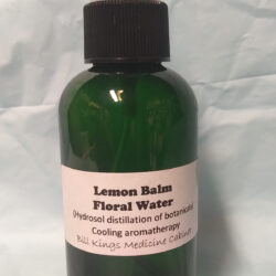 Green bottle of Lemon Balm Floral Water with spray nozzle.