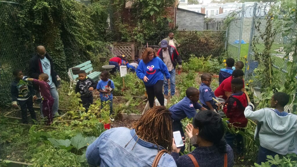 A group of people gardening together in an outdoor space.